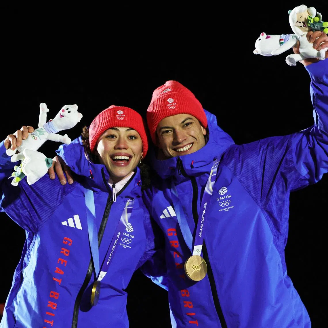 Milano Cortina 2026 Olympics - Skeleton - Mixed Team Victory Ceremony - Cortina Sliding Centre, Cortina d'Ampezzo, Italy - February 15, 2026. Gold medallists Tabitha Stoecker of Britain and Matt Weston of Britain celebrate on the podium during the Skeleton Mixed Team Victory Ceremony. REUTERS/Athit Perawongmetha