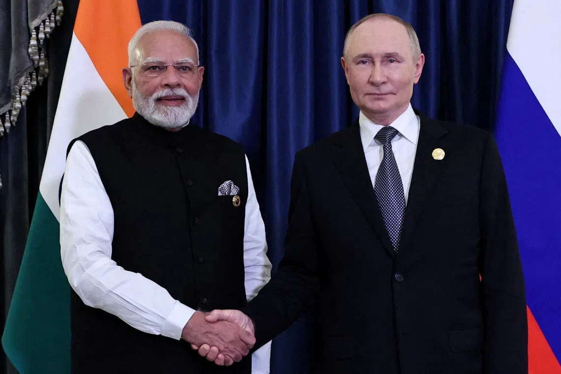 FILE PHOTO: Russian President Vladimir Putin and Indian Prime Minister Narendra Modi shake hands during a meeting on the sidelines of the Shanghai Cooperation Organisation (SCO) summit in Tianjin, China, September 1, 2025. Sputnik/Alexander Kazakov/Pool via REUTERS/File Photo