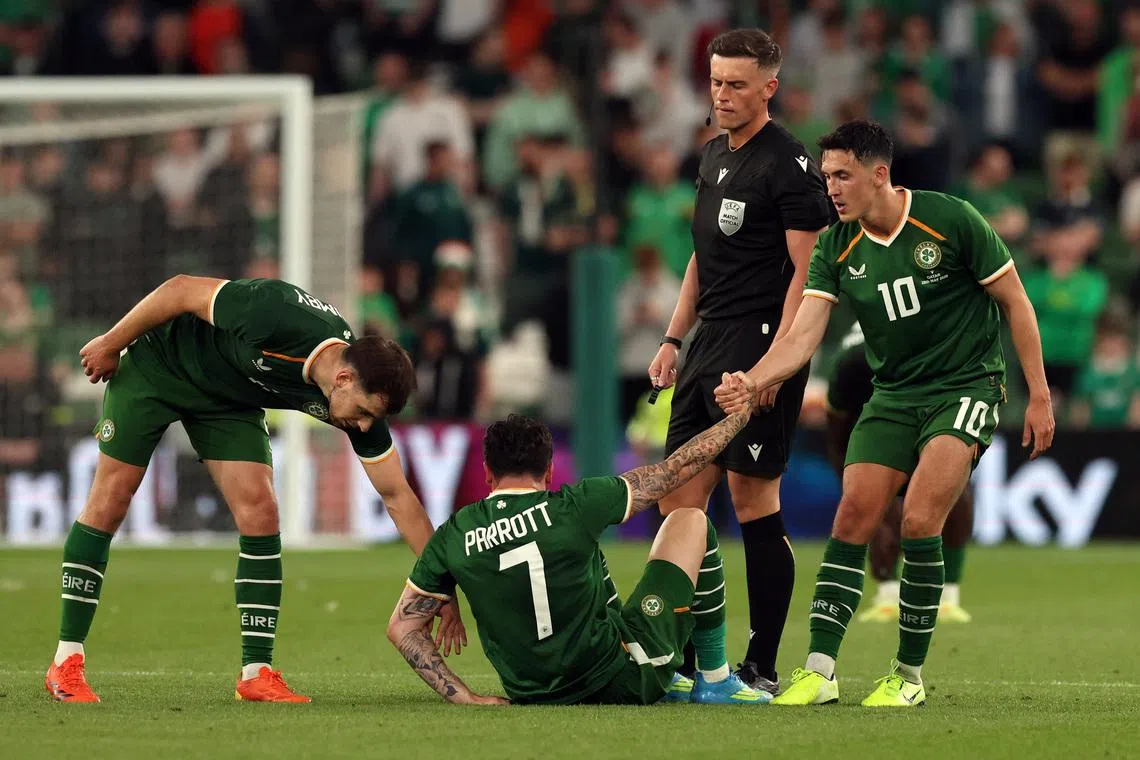 Soccer Football - International Friendly - Republic of Ireland v Qatar - Aviva Stadium, Dublin, Ireland - May 28, 2026 Republic of Ireland's Jayson Molumby and Jamie McGrath help Troy Parrott to his feet REUTERS/Cathal Mcnaughton