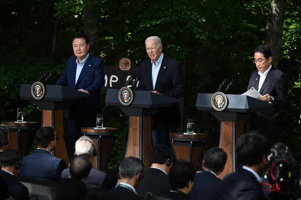 US President Joe Biden (centre), South Korean President Yoon Suk Yeol (left) and Japanese Prime Minister Fumio Kishida hold a press conference after their Camp David talks.
