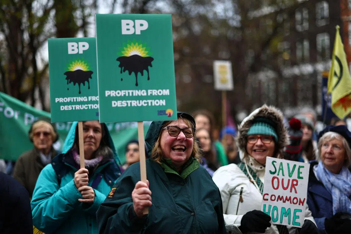 Environmental activists hold up placards during a demonstration outside the headquarters of BP (formerly British Petroleum) in central London on December 9, 2023, gathering in solidarity with people on the frontlines of the climate crisis. Climate negotiators at the COP28 talks in Dubai are tussling over the future of oil, gas and oil, responsible for the lion's share of humanity's planet-heating emissions. (Photo by HENRY NICHOLLS / AFP)
