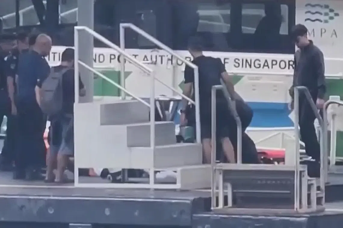 First aid being performed on the 22-year-old Malaysian diver at Marina South Pier. 