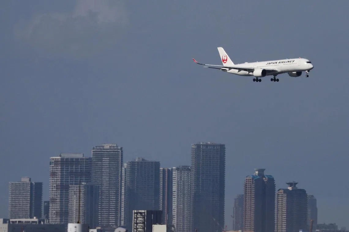 FILE PHOTO: A Japan Airlines (JAL) aircraft approaches to land at Tokyo International Airport, also known as Haneda Airport, in Tokyo, Japan April 29, 2023. REUTERS/Issei Kato/File Photo