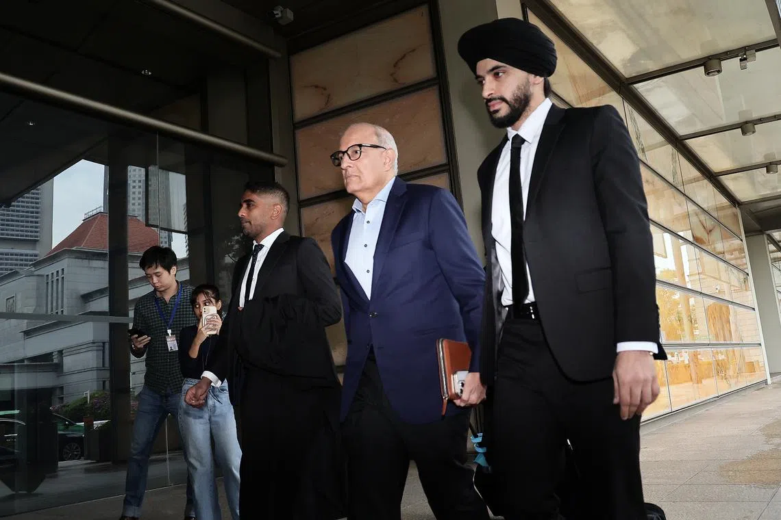 Former transport minister S. Iswaran arriving at the Supreme Court with his lawyers on May 8.