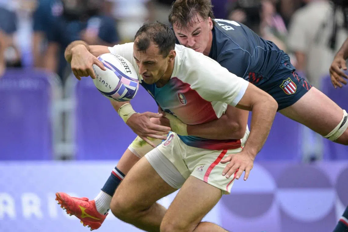 Orrin Bizer (right), of the US, tackles France's Paulin Riva, during their rugby sevens match, on July 24.