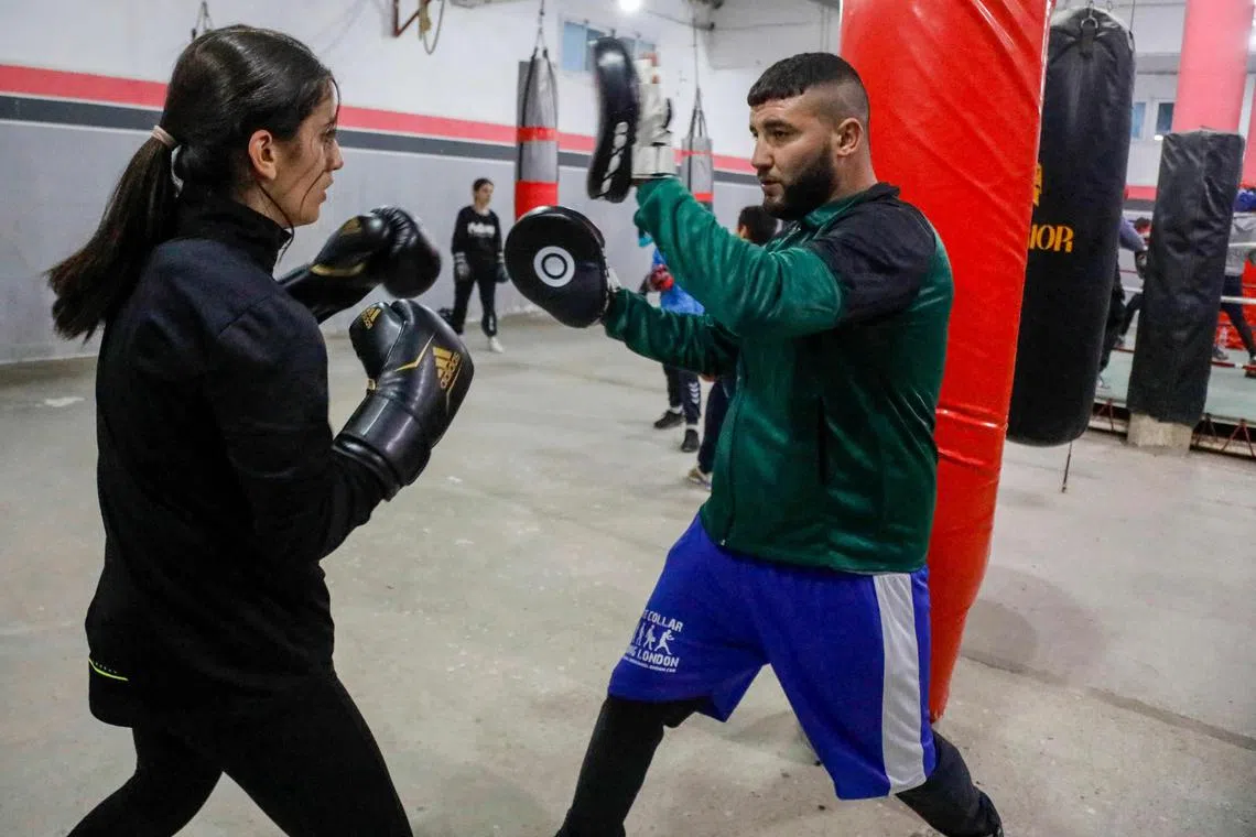 Algerian junior boxing champion for 2025 Cerine Kessal (left), practices drills with a trainer at a club in Azazga town in Algeria's Tizi Ouzou province on Feb 25, 2025. Algerian boxer Imane Khelif's 2024 Olympic gold aroused newfound interest among girls and women in her country for the male-dominated sport, with gyms across the North African country witnessing a surge in memberships.