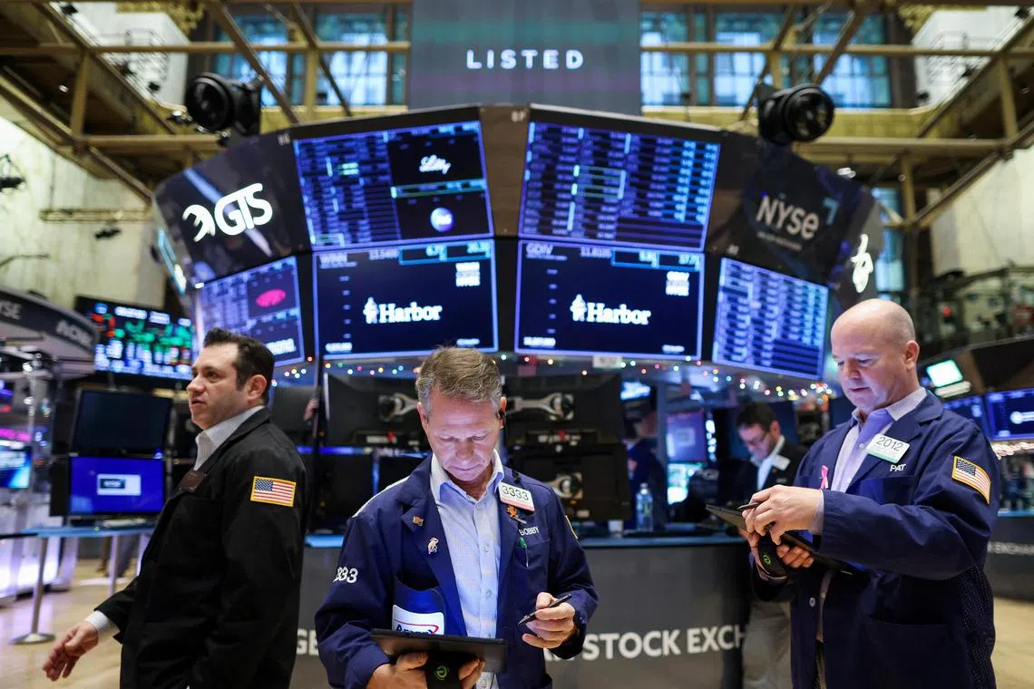 Traders work on the trading floor at the New York Stock Exchange (NYSE) in New York City, U.S., January 5, 2023. REUTERS/Andrew Kelly/File Photo