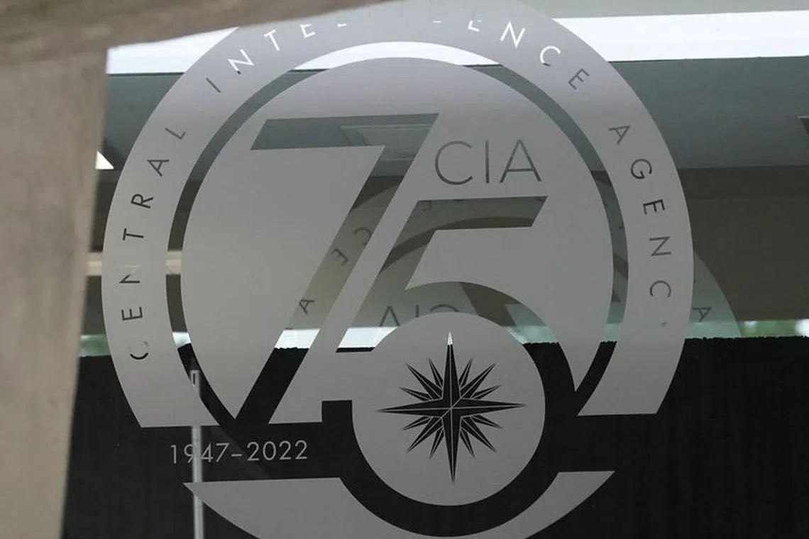 A glass door bears a commemorative seal marking 75 years at CIA headquarters in Langley, Virginia, U.S., July 8, 2022. REUTERS/Kevin Lamarque/File Photo