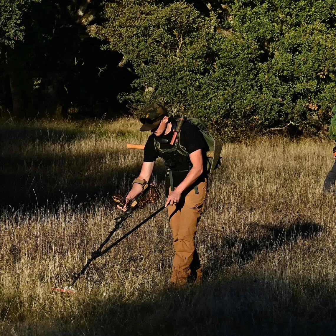 YouTuber Matt James (left) and Mr Cody Blanchard of Heritage Gold Rush use metal detectors to detect gold in El Dorado County,   California. 