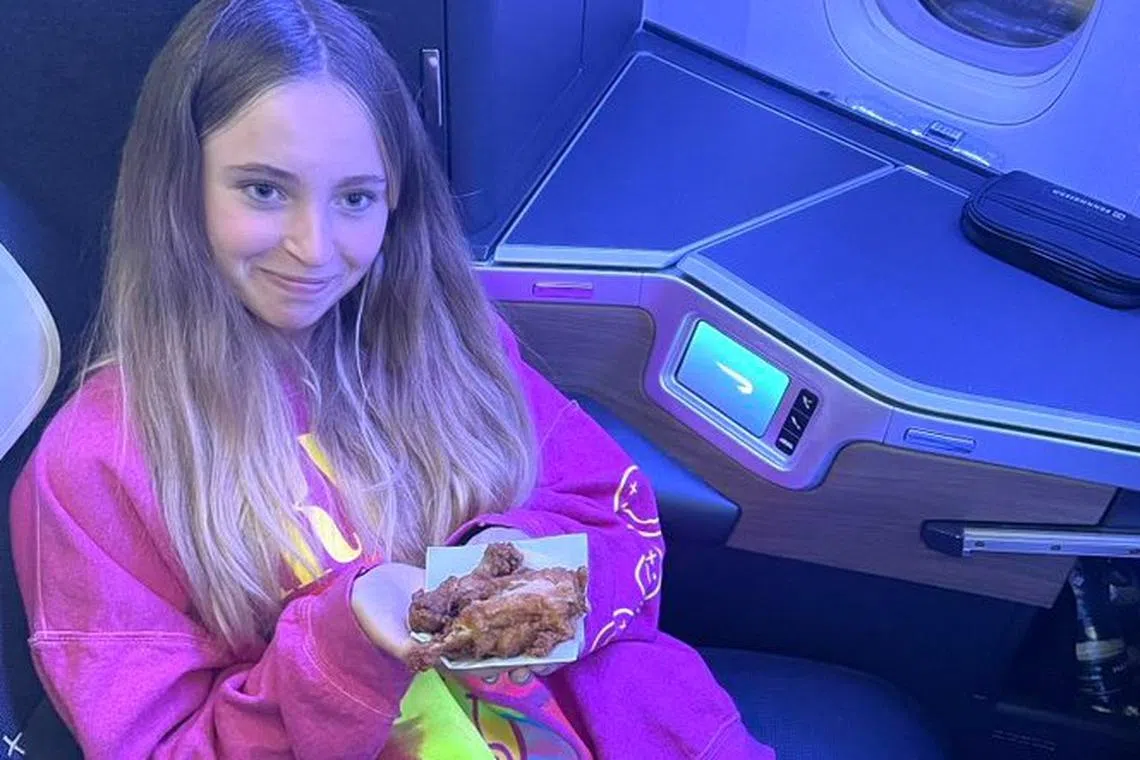 A British Airways passenger shows the fried chicken she got for her only meal on a 12-hour flight from the Bahamas.