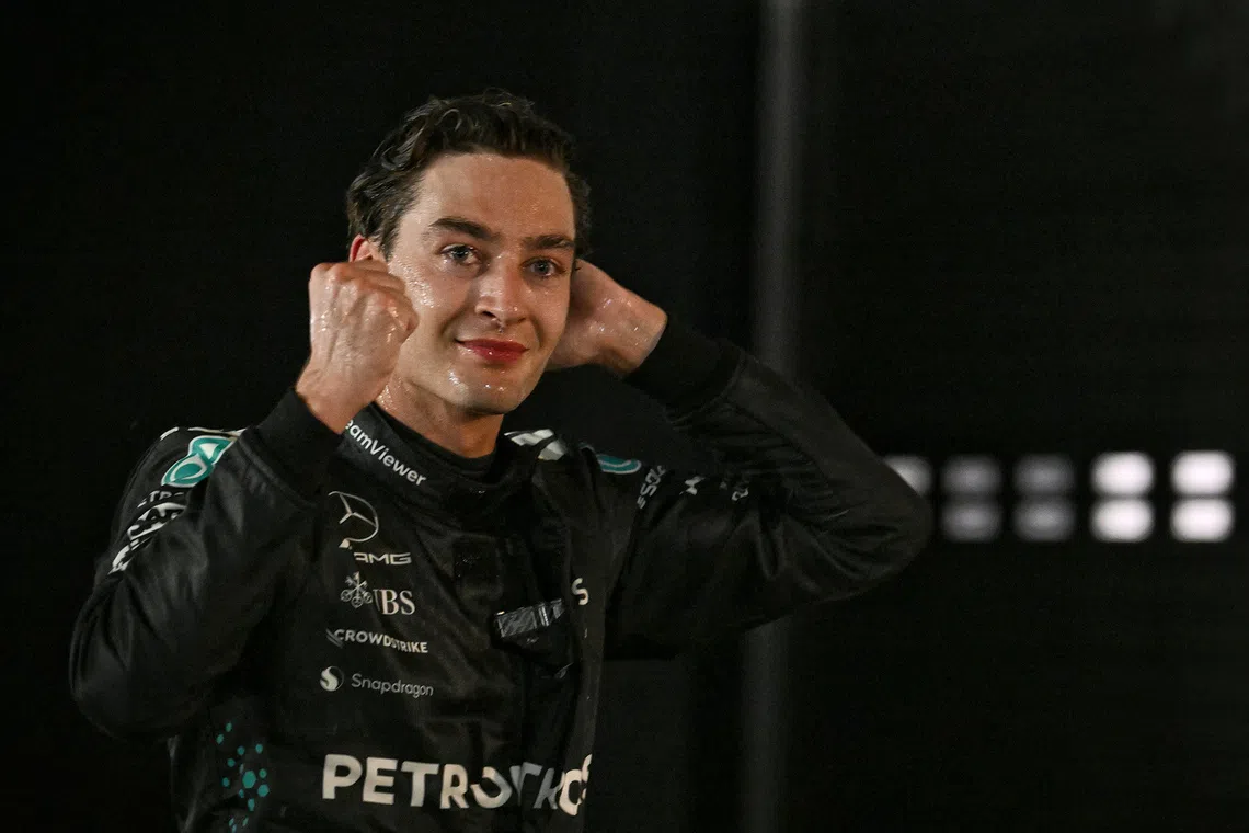 Mercedes' George Russell smiles for the cameras after winning the 2025 Formula One Singapore Airlines Singapore Grand Prix at the Marina Bay Street Circuit on Oct 5, 2025. 