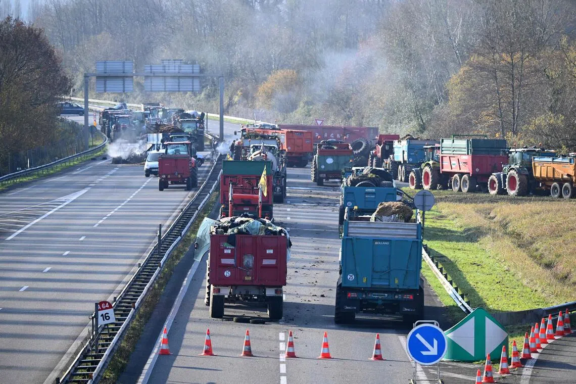 Tractors blocking a motorway in southwestern France on Dec 13, as farmers protest over what they see as the heavy-handed culling of cows over lumpy skin disease. 