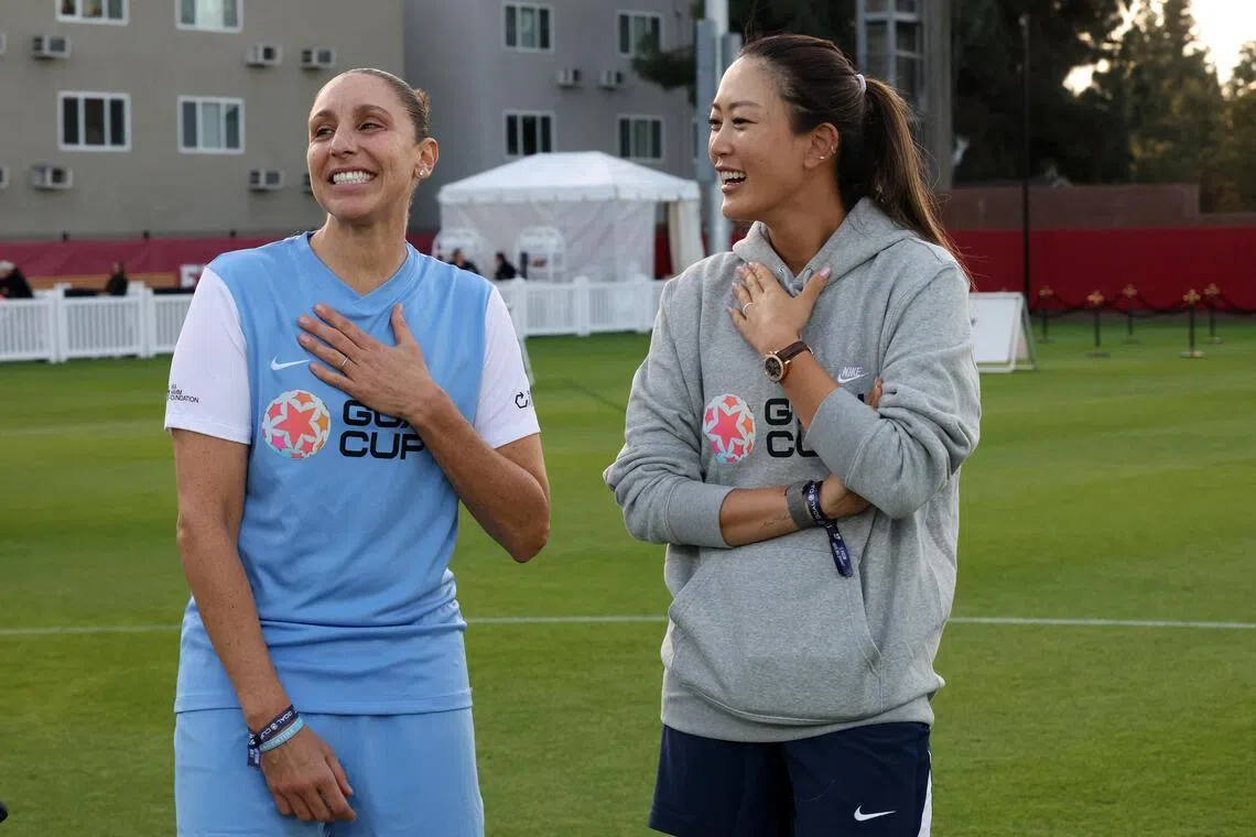 Former basketballer Diana Taurasi (left) and Michelle Wie West on the field before the Goal Cup Celebrity Soccer Match at Rawlinson Stadium on Jan 17.