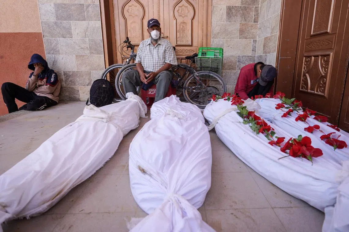 Palestinians mourn relatives whose bodies were unearthed from purported mass graves at Nasser hospital in southern Gaza.