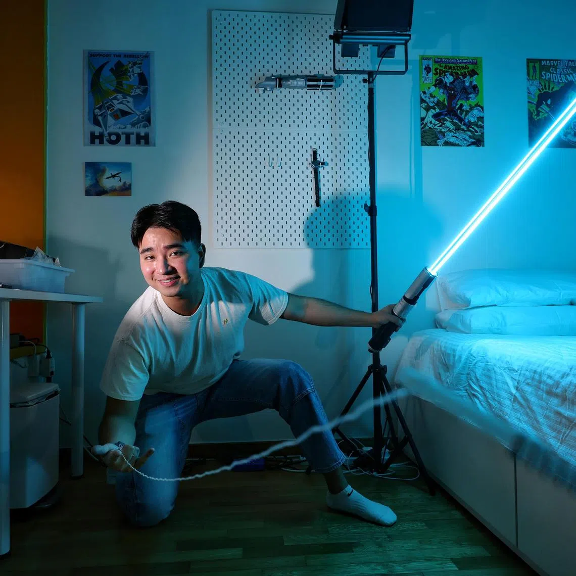 ST20250415_202502200883/ocsaber15/Kevin Lim/Osmond Chia/

Portrait of Mr Jacob Uy, a 25-year-old Singaporean graduate from Massachusetts who turns science fiction gadgets into real life, with the
lightsaber and web shooter he built in his room as a student on April 15, 2025. The gadgets are now being developed and sold under his start-up Herotech.