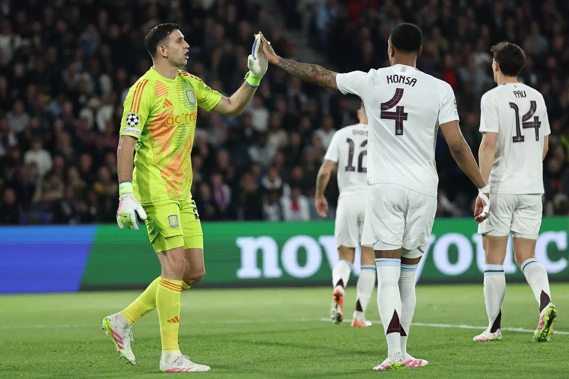 Soccer Football - Champions League - Quarter Final - First Leg - Paris St Germain v Aston Villa - Parc des Princes, Paris, France - April 9, 2025 Aston Villa's Emiliano Martinez and Ezri Konsa react REUTERS/Christian Hartmann