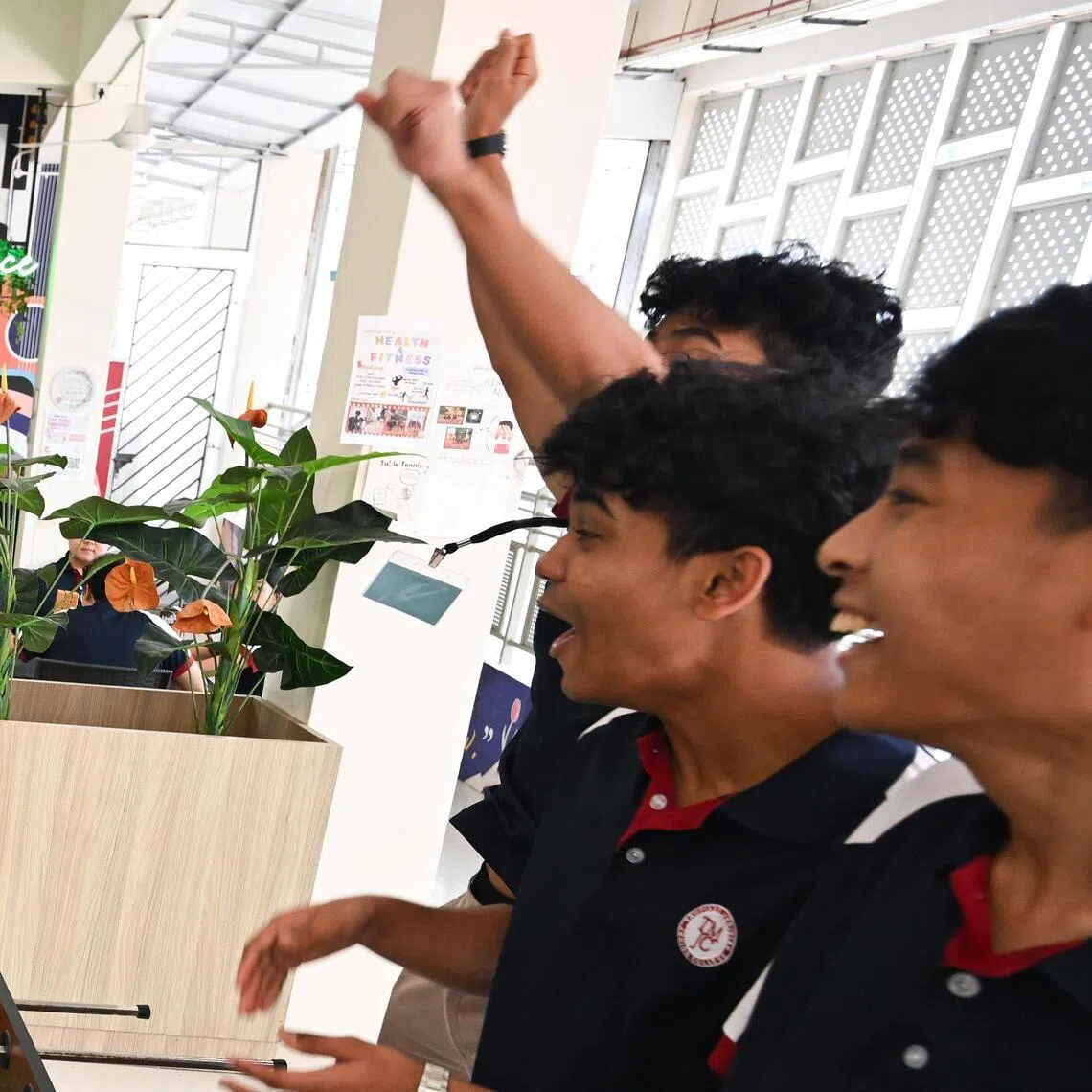 Students playing foosball on March 10 at Tampines Meridian Junior College, where the canteen comprises four distinct zones for different uses, including a performance space.