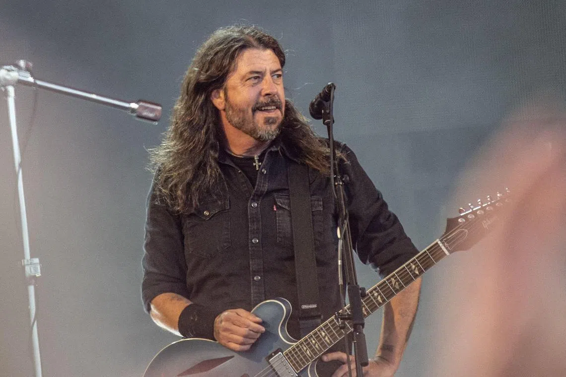 US musician Dave Grohl of rock band Foo Fighters performs on the Orange Stage at Roskilde Festival on July 5, 2024 in Roskilde, Denmark. (Photo by Helle Arensbak / Ritzau Scanpix / AFP) / Denmark OUT