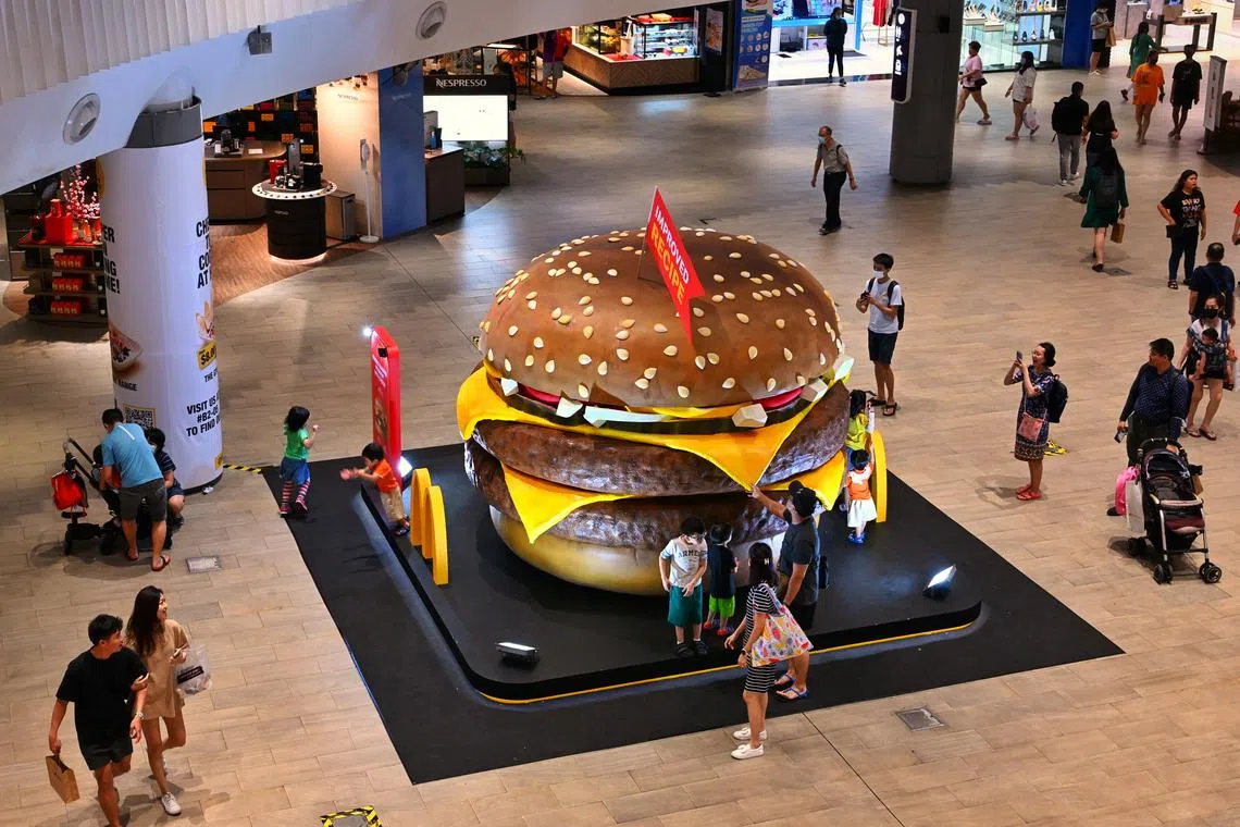 People having fun at the McDonald’s exhibit at Waterway Point mall on February 6, 2023. The fast food chain has set up a giant burger exhibit to advertise their Double Quarter Pounder with Cheese burger. Can be used for fast food stories.