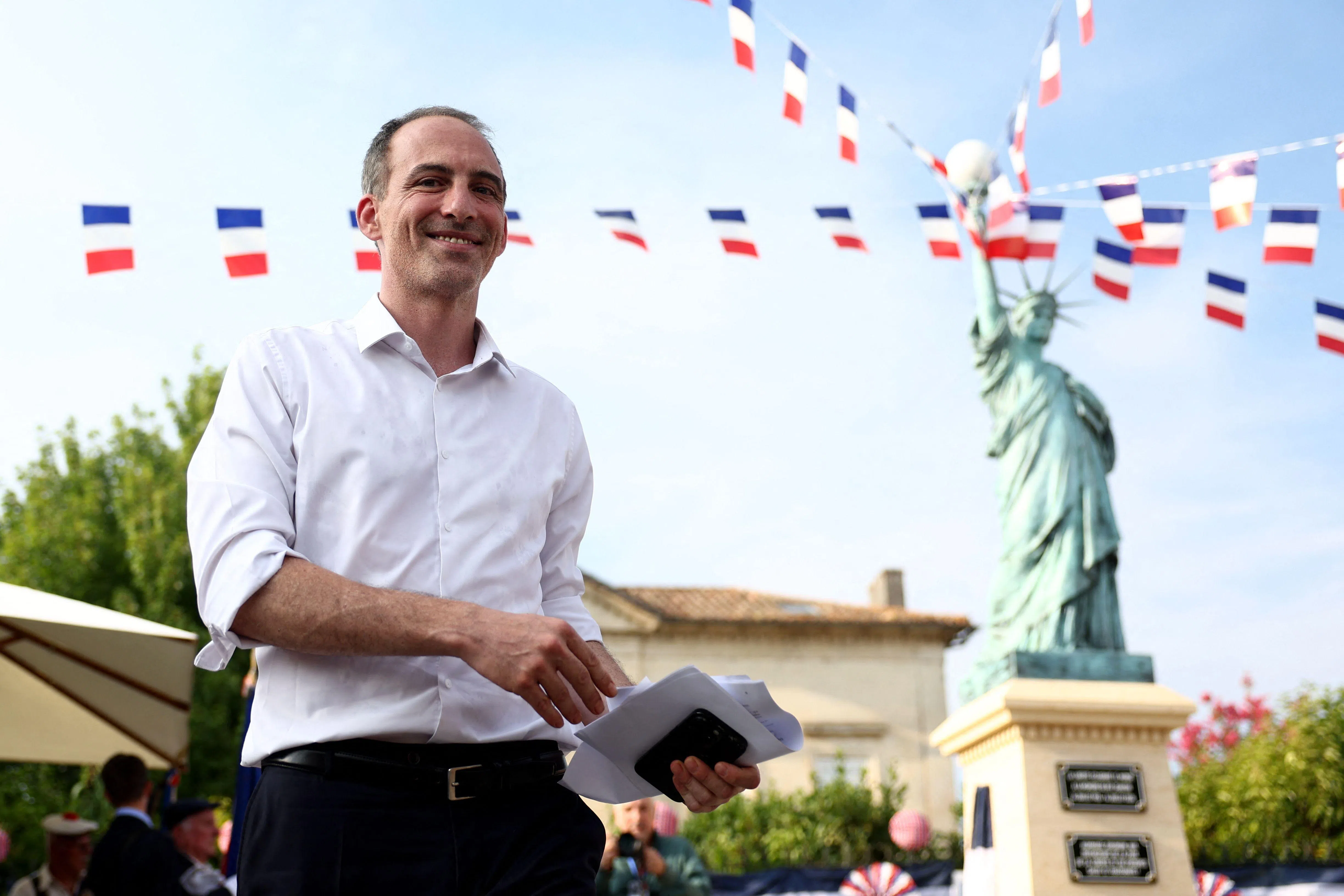 French politician, centre-left party Place publique's leader and MEP Raphael Glucksmann walks during the 100th Anniversary of the Unveiling of the Statue of Liberty, which donated to the city by a local man named Rey Jeanton, in Izon near Bordeaux, south-western France, on July 14, 2026. (Photo by ROMAIN PERROCHEAU / AFP)