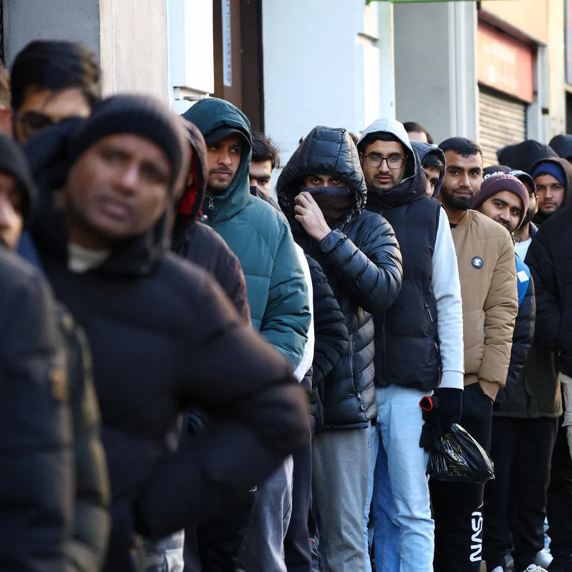 People queue outside Pakistan’s consulate in Barcelona to apply for criminal record certificates, a document required for the migrant regularisation programme recently announced by the Spanish government, in Barcelona, Spain. January 30, 2026. Spain plans to grant legal status to about half a million undocumented migrants. REUTERS/Albert Gea