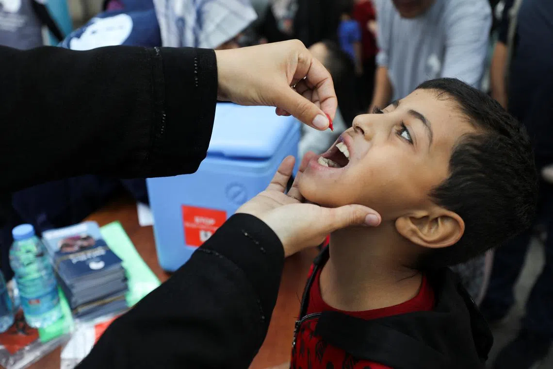 FILE PHOTO: A Palestinian child is vaccinated against polio during the second round of a vaccination campaign, amid the Israel-Hamas conflict, in Gaza City, November 2, 2024. REUTERS/Dawoud Abu Alkas/File Photo