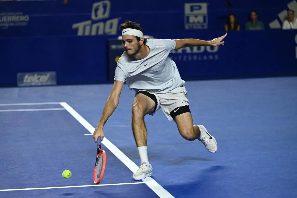 Taylor Fritz returns the ball against Tommy Paul during the Mexico Open semi-finals.