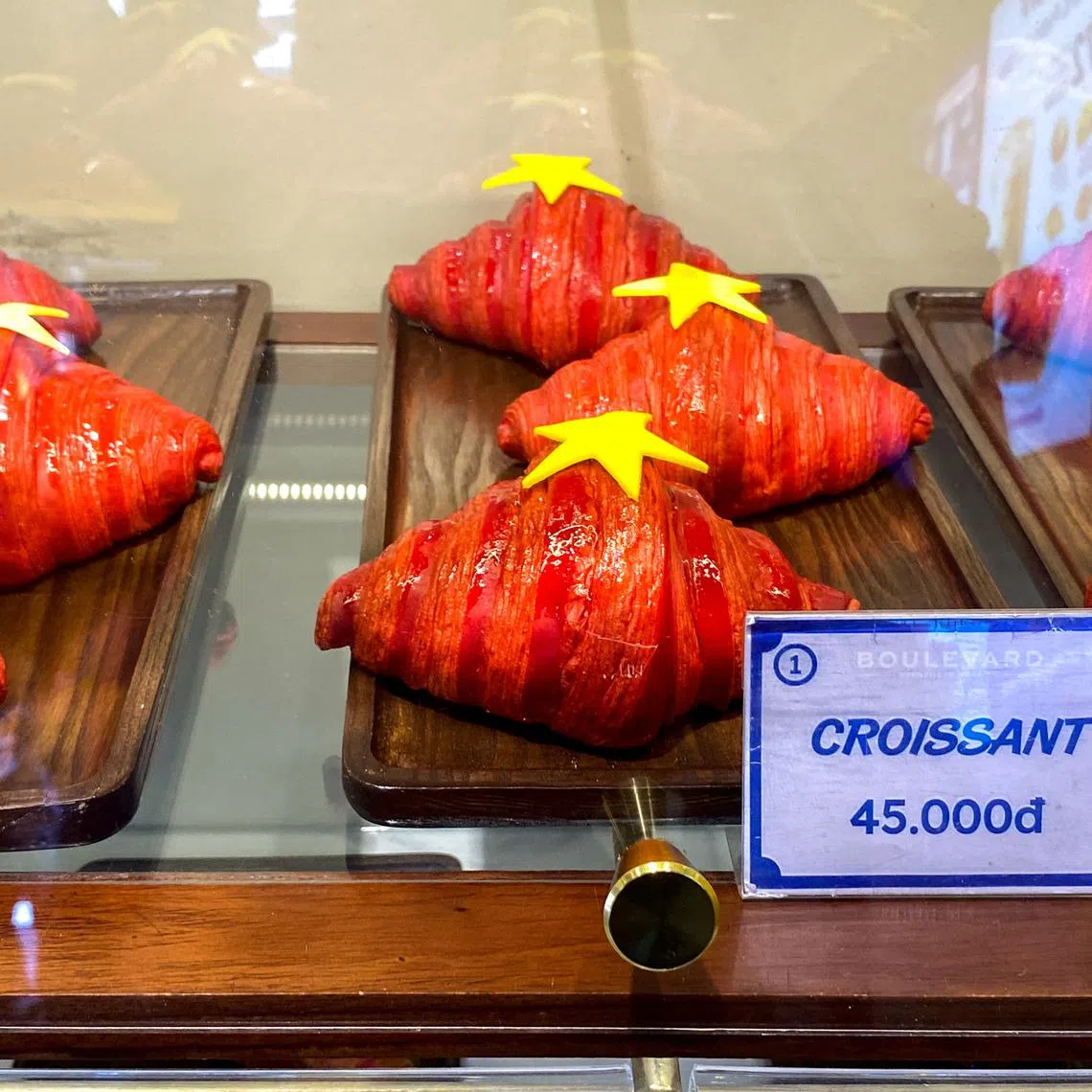 Red croissants decorated with yellow stars are displayed at a bakery shop in Hanoi, Vietnam, August 31, 2025. REUTERS/Francesco Guarascio