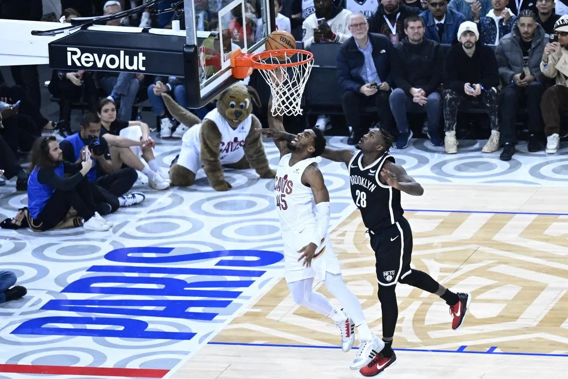 Cleveland Cavaliers guard Donovan Mitchell (No. 45) shooting against Brooklyn Nets' Dorian Finney-Smith in the NBA Paris game at AccorHotels Arena. 
