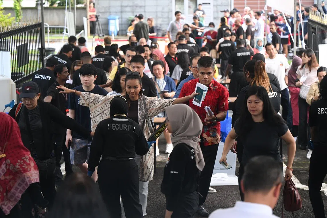 Voters going through security checks at the Indonesian Embassy in Singapore to cast their ballot for the elections, on Feb 11.