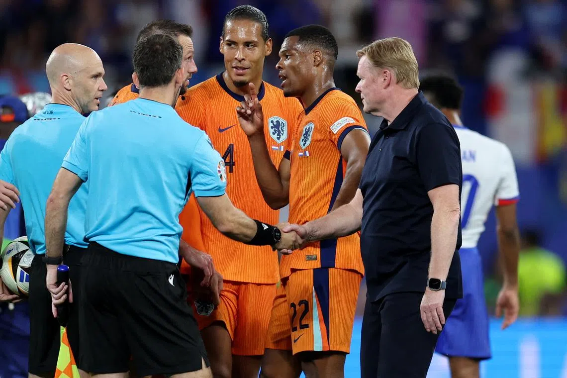 Soccer Football - Euro 2024 - Group D - Netherlands v France - Leipzig Stadium, Leipzig, Germany - June 21, 2024  Netherlands coach Ronald Koeman shakes hands with with the match officials as Denzel Dumfries reacts REUTERS/Karina Hessland