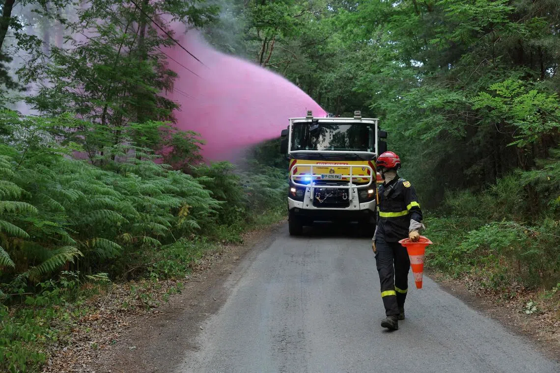 A fire truck sprays fire retardant during a fire in the Fontainebleau Forest in Noisy-sur-Ecole, near Paris, on July 13.