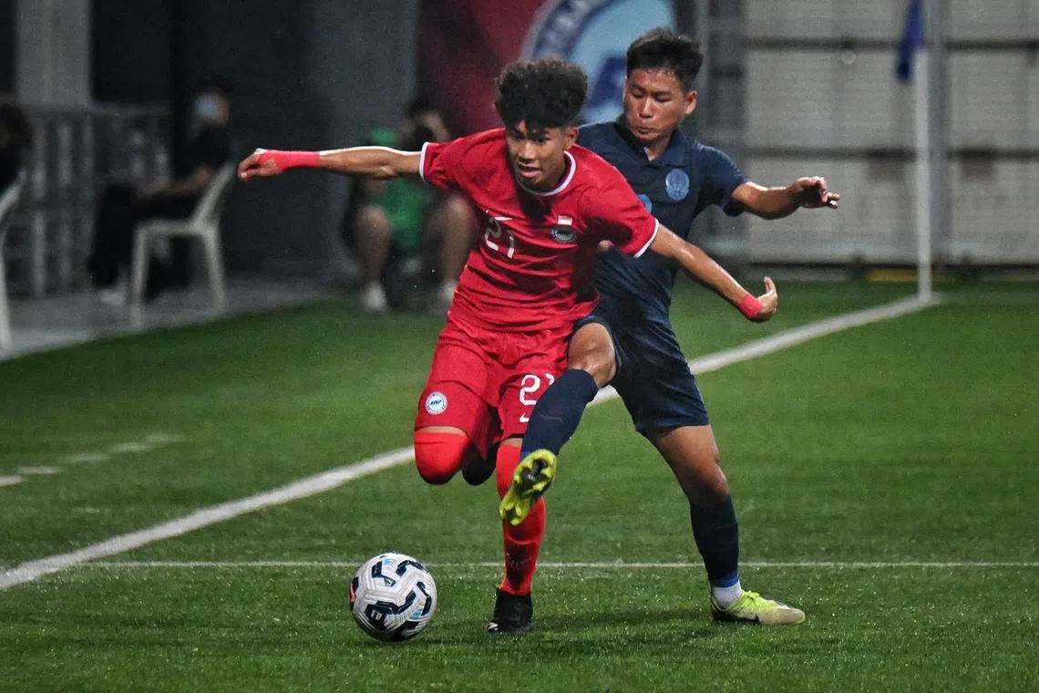 Singapore's Ahmad Izzan Rifqi vying for the ball with Cambodia's Sanh Sokchea at the Lion City Cup Under-16 boys match at the Jalan Besar Stadium, on July 11.