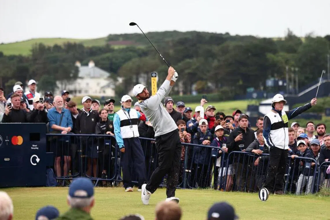 Caption:
US golfer Scottie Scheffler plays from the 18th tee on day two of the 153rd Open Championship at Royal Portrush golf club in Northern Ireland on July 18, 2025. (Photo by HENRY NICHOLLS / AFP) / RESTRICTED TO EDITORIAL USE