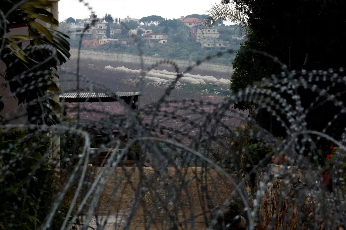 FILE PHOTO: Razor wire lies near an abandoned house, amid ongoing cross-border hostilities between Hezbollah and Israeli forces, near Israel?s border with Lebanon in northern Israel March 19, 2024. REUTERS/Carlos Garcia Rawlins/File Photo