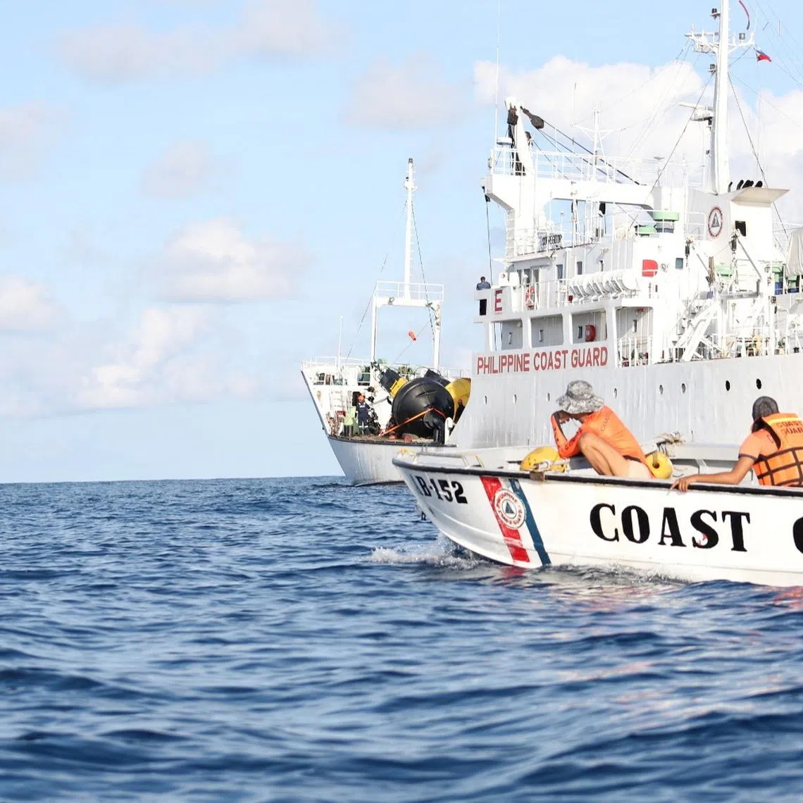 Philippine Coast Guard personnel installing navigational buoys in the Philippines' exclusive economic zone in the South China Sea. 