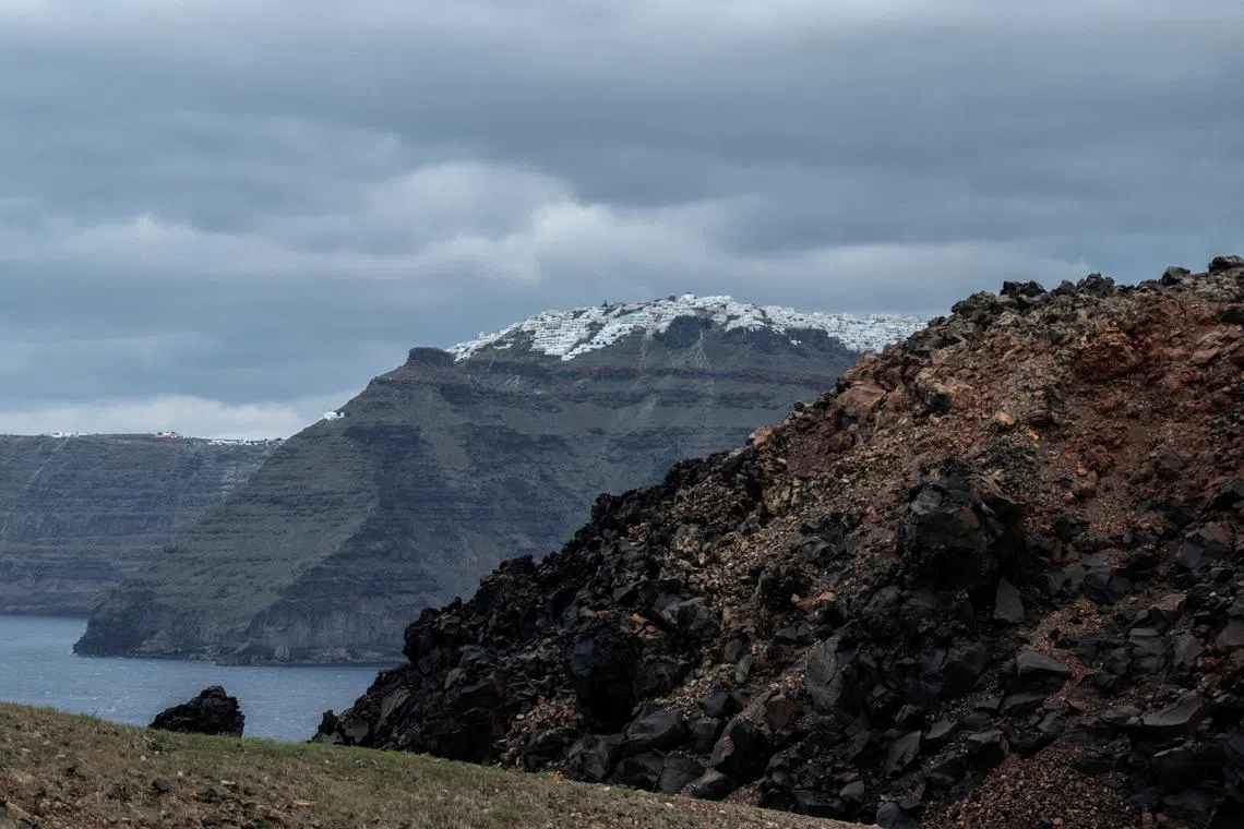 FILE PHOTO: A view of the island of Santorini (back) as seen from the volcanic island of Nea Kameni, Greece, February 10, 2025. REUTERS/Max Gyselinck/File Photo
