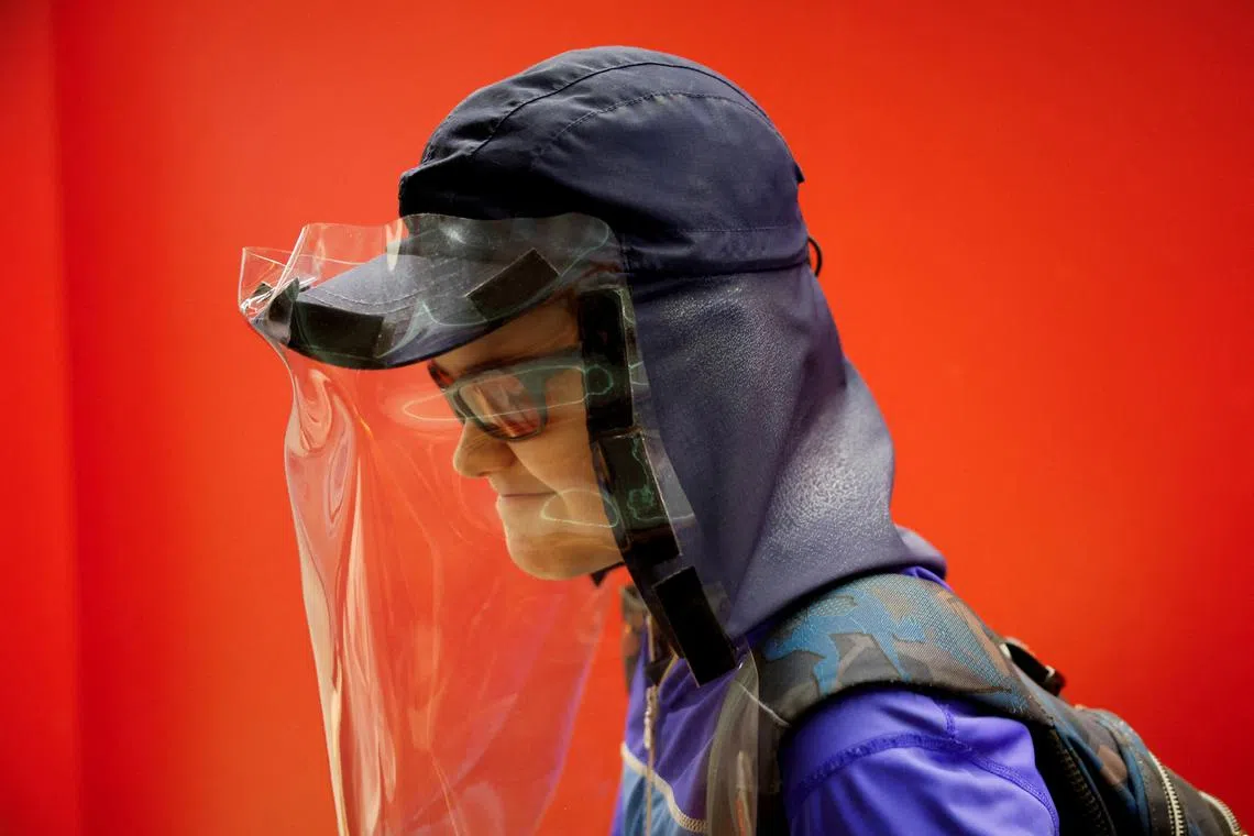 Pol Dominguez Aranda, 11, who is diagnosed with Xeroderma pigmentosum - extreme sensitivity to ultraviolet rays - wears UV protection gear to leave school in Barcelona, Spain, June 18, 2024. REUTERS/ Albert Gea