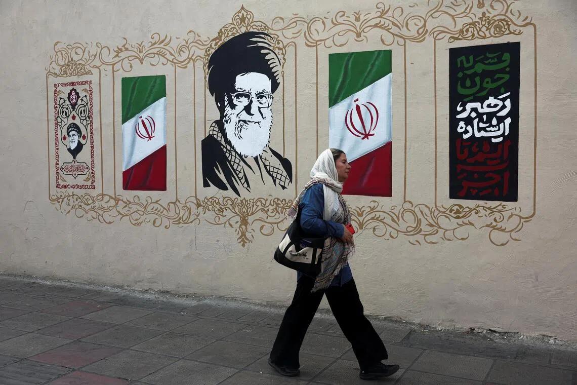 A woman walks by a mural depicting Iran's late Supreme Leader Ayatollah Ali Khamenei, on a street in Tehran, Iran, August 13, 2026. Majid Asgaripour/WANA (West Asia News Agency) via REUTERS ATTENTION EDITORS - THIS PICTURE WAS PROVIDED BY A THIRD PARTY. ISRAEL OUT. NO COMMERCIAL OR EDITORIAL SALES IN ISRAEL. NO ACCESS FOR ISRAELI MEDIA. NO USE BBC PERSIAN. NO USE VOA PERSIAN. NO USE MANOTO. NO USE IRAN INTERNATIONAL. NO USE RADIO FARDA. DIGITAL: NO USE BBC PERSIAN. NO USE VOA PERSIAN. NO USE MANOTO. NO USE IRAN INTERNATIONAL. NO USE RADIO FARDA.