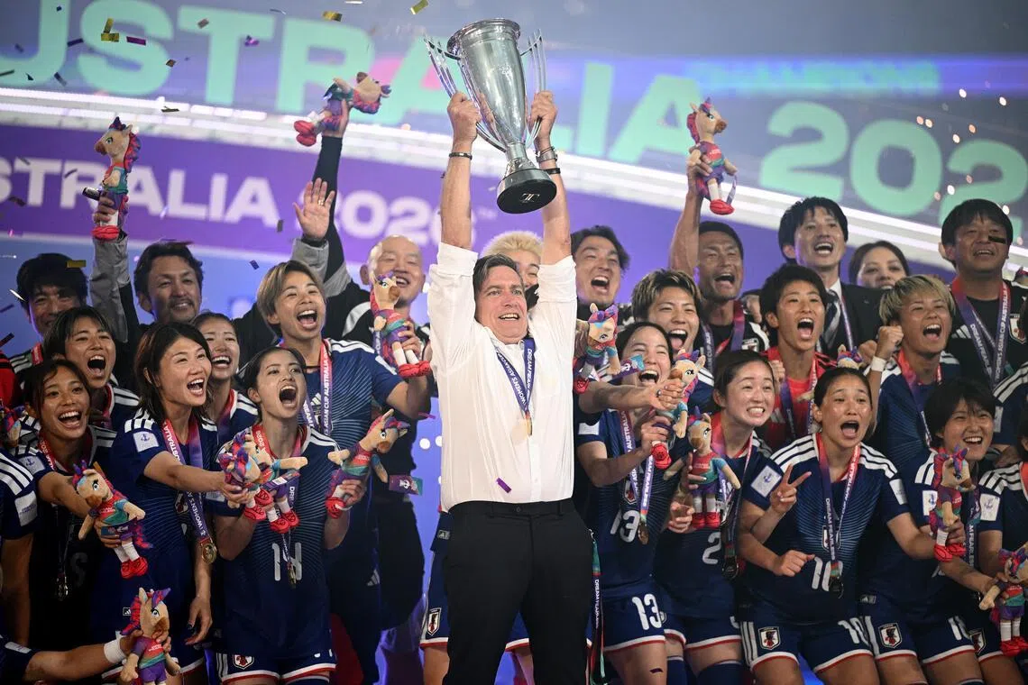 Outgoing Japan coach Nils Nielsen lifting the trophy as Japan celebrate winning the Women’s Asian Cup after beating hosts Australia 1-0 at Stadium Australia in Sydney on March 21, 2026.