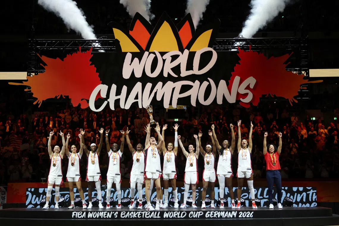Basketball - FIBA Basketball Women's World Cup - Final - United States v France - Uber Arena, Berlin, Germany - September 13, 2026 Breanna Stewart of the U.S. lifts the trophy with teammates and head coach Kara Lawson after winning the FIBA Women's World Cup Final REUTERS/Maryam Majd