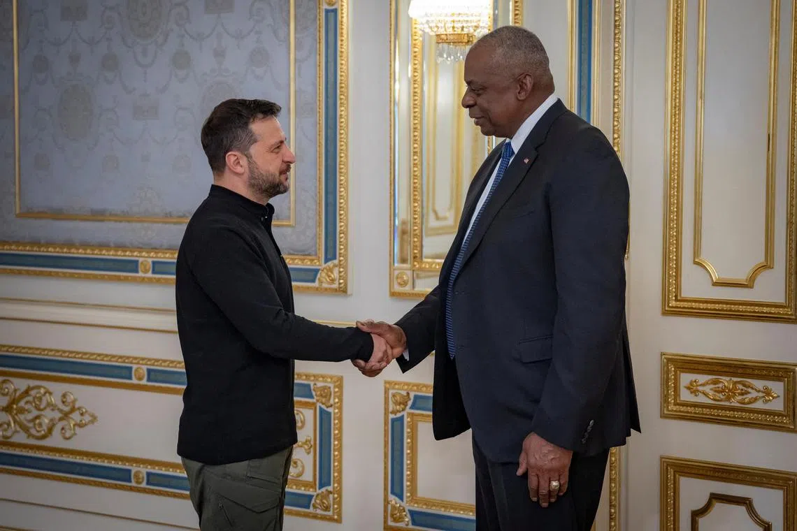 Ukraine's President Volodymyr Zelensky welcomes US Defence Secretary Lloyd Austin, in Kyiv, Ukraine, on Oct 21..