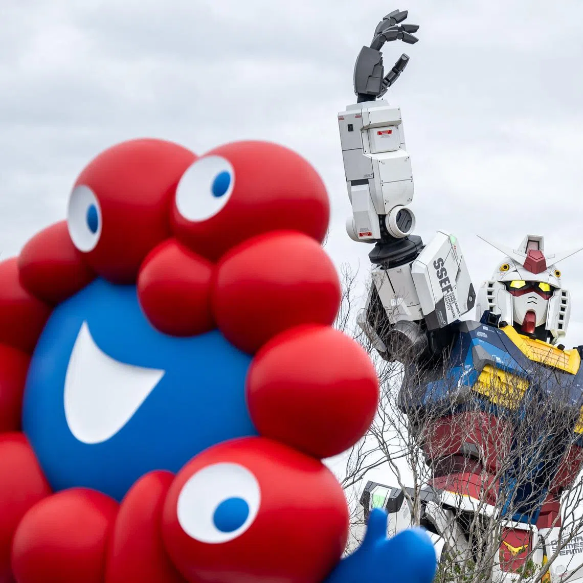 A general view shows the "Myaku-Myaku", the mascot of the 2025 Osaka Expo as the Gundam pavilion is seen behind on the first day of the six-month event on April 13.