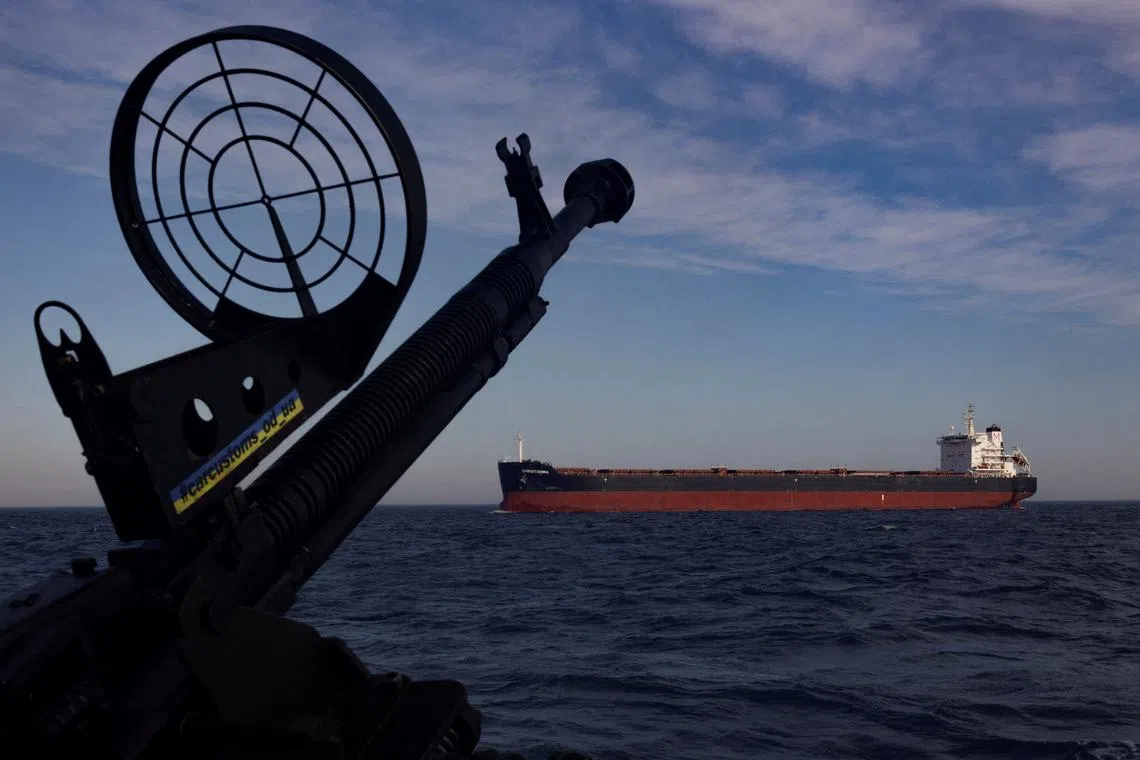 FILE PHOTO: A cargo ship passes a patrol boat of Ukraine’s cost guard in the Black Sea, amid Russia’s attack on Ukraine, February 7, 2024. REUTERS/Thomas Peter/File Photo