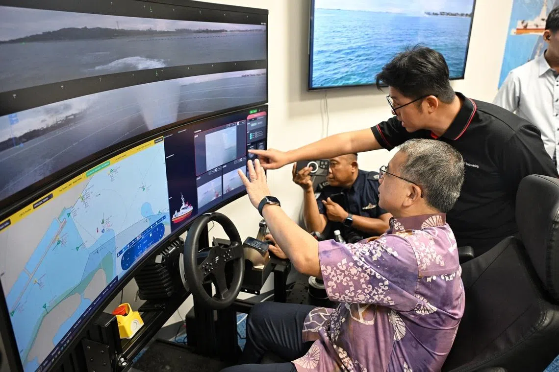 Second Minister for Home Affairs Edwin Tong trying his hand at an unmanned surface vessel control during a tour of the new SCDF Marine Division Headquarters on June 19.
