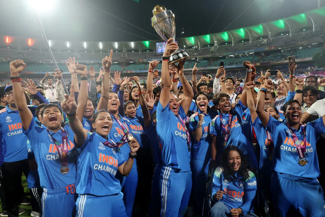 Cricket - ICC Women's World Cup - Final - India v South Africa - DY Patil Stadium, Navi Mumbai, India - November 2, 2025 India's Harmanpreet Kaur and teammates celebrate with the trophy after winning the ICC Women's World Cup REUTERS/Francis Mascarenhas
