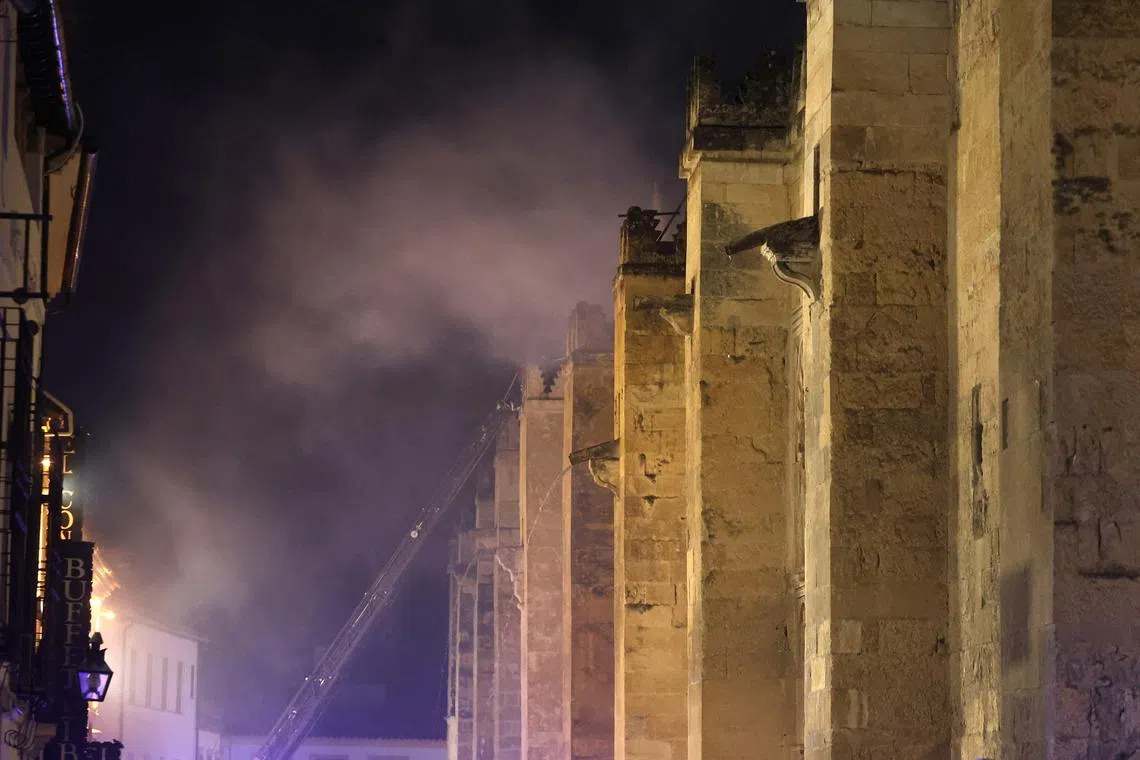 Firefighters work to extinguish a fire which broke out in the historic mosque-turned-cathedral in the southern Spanish city of Cordoba on Aug 8, 2025.