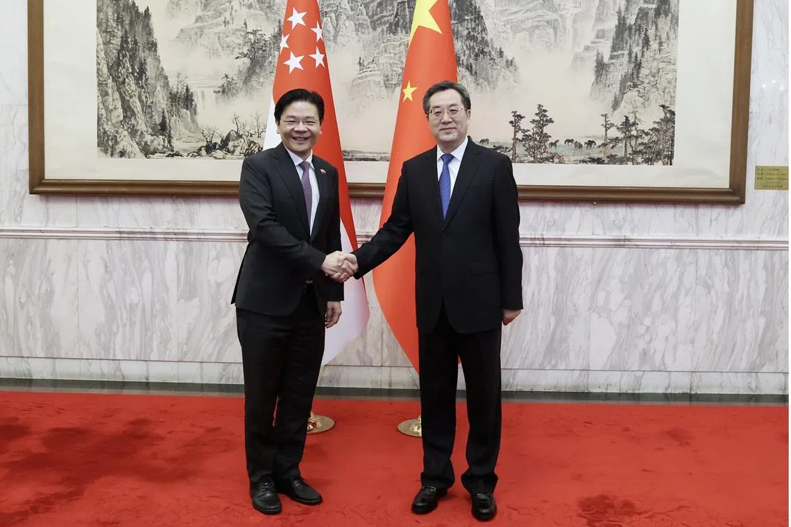 Deputy Prime Minister Lawrence Wong (left) met China's Vice-Premier Ding Xuexiang in May 2023.