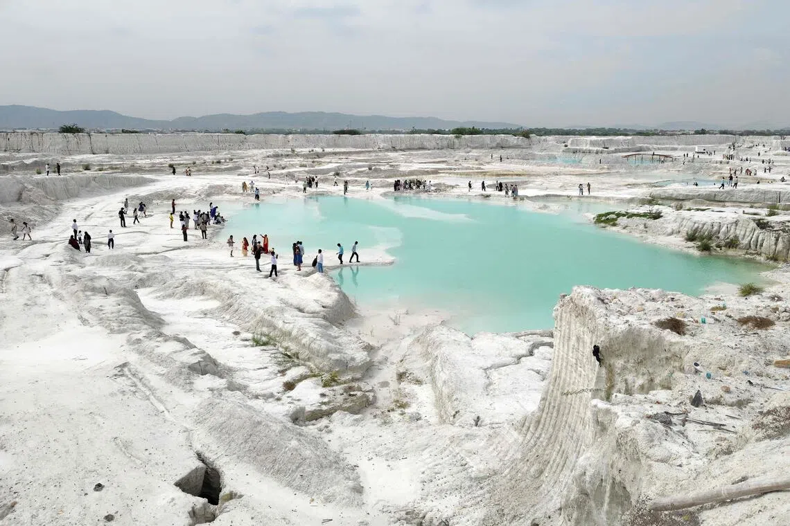 Tourists visit the marble-waste dumping yard in Rajasthan’s Kishangarh city on Aug 16.