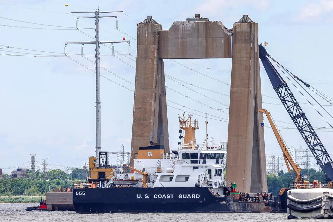 A U.S. Coast Guard boat approaches clean-up operations at the Francis Scott Key Bridge as the main shipping channel prepares to fully reopen, in Baltimore, Maryland, U.S., June 10, 2024. REUTERS/Evelyn Hockstein